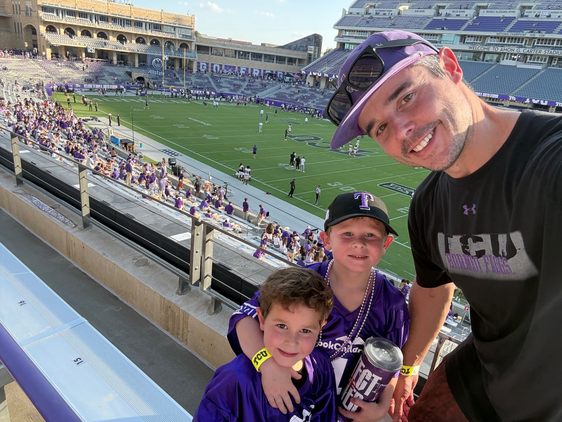Daniel Smith with two children at a football stadium